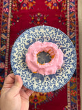 Pink donut on vintage plate